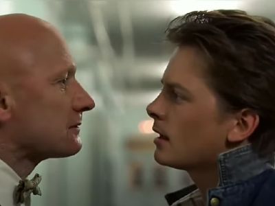 James Tolkan and Michael J. Fox are staring at one another.